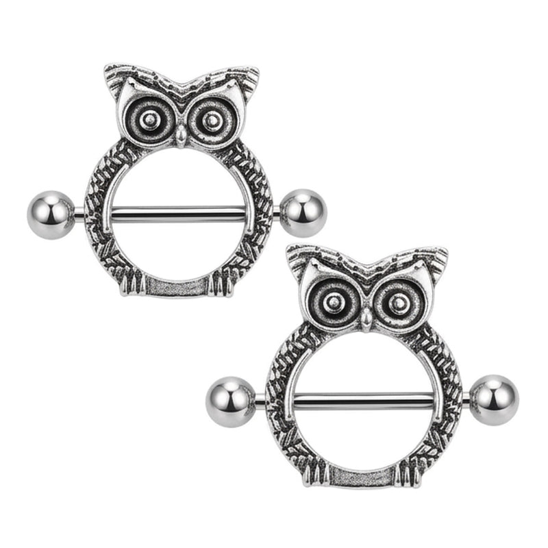 A pair of Gothic style owl nipple piercing jewelry on a white background.