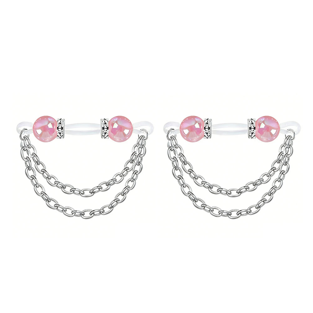 A pair of vibrant pink iridescent pearl non-pierced nipple rings with silver tone chains.