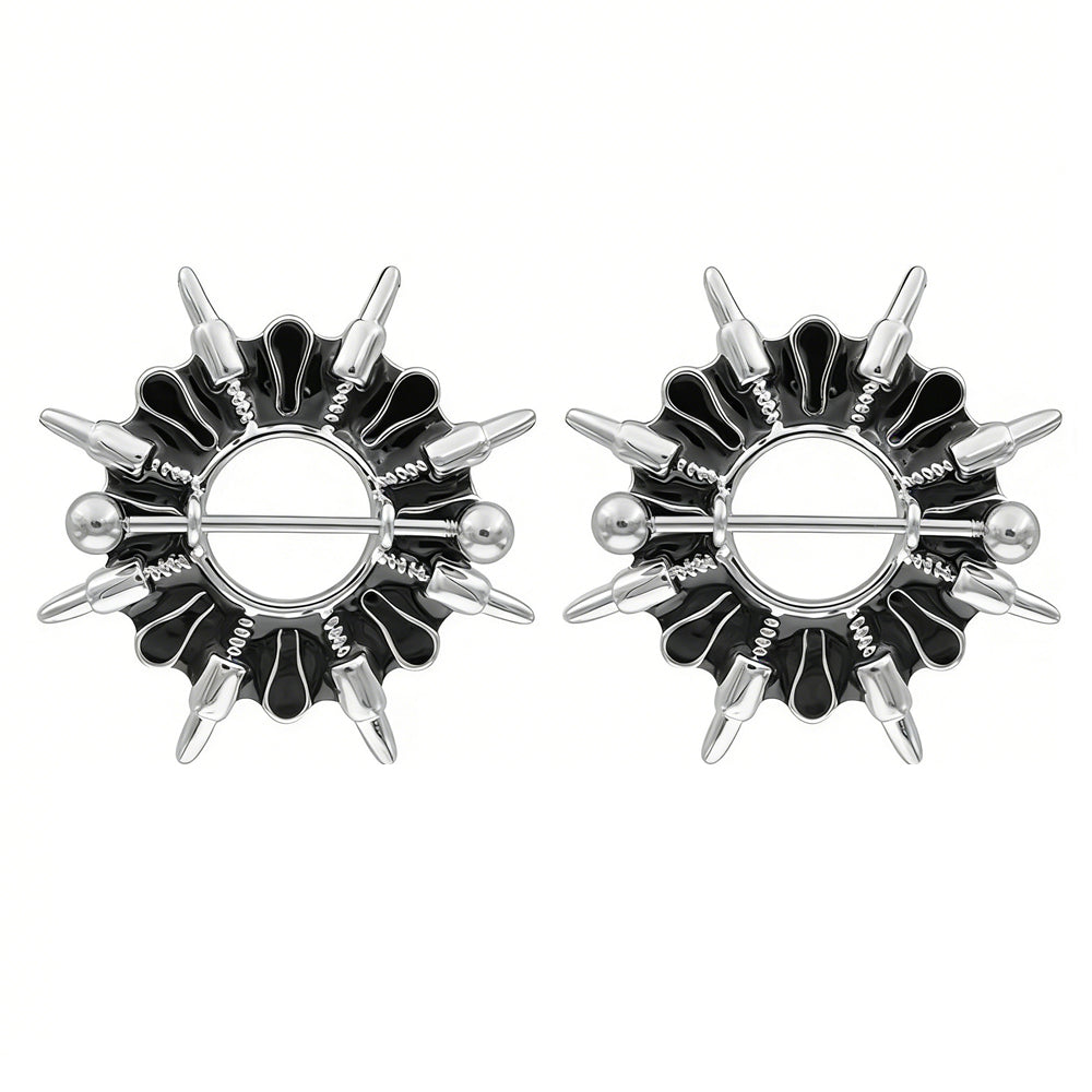 A pair of punk style spiked nipple rings on a white background