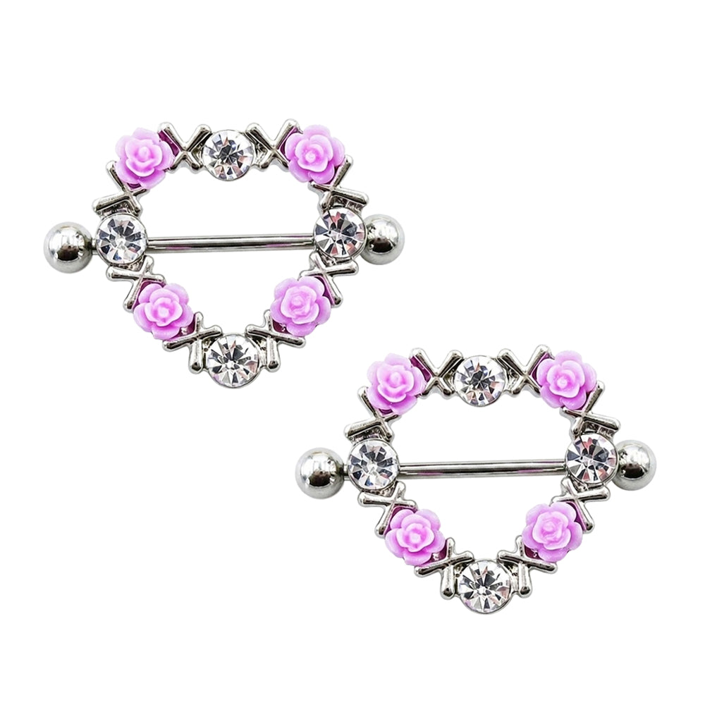 A matching pair of silver heart nipple shield rings with 3D pink resin roses and cubic zirconia, ideal for coquette alternative body jewelry styling, white background.
