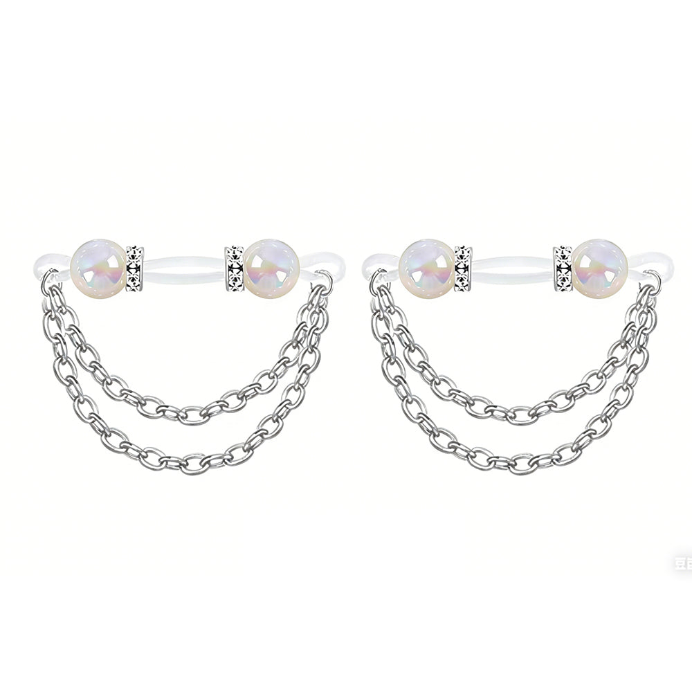 A pair of non-pierced nipple rings featuring white shimmer pearls and aesthetic body chains.