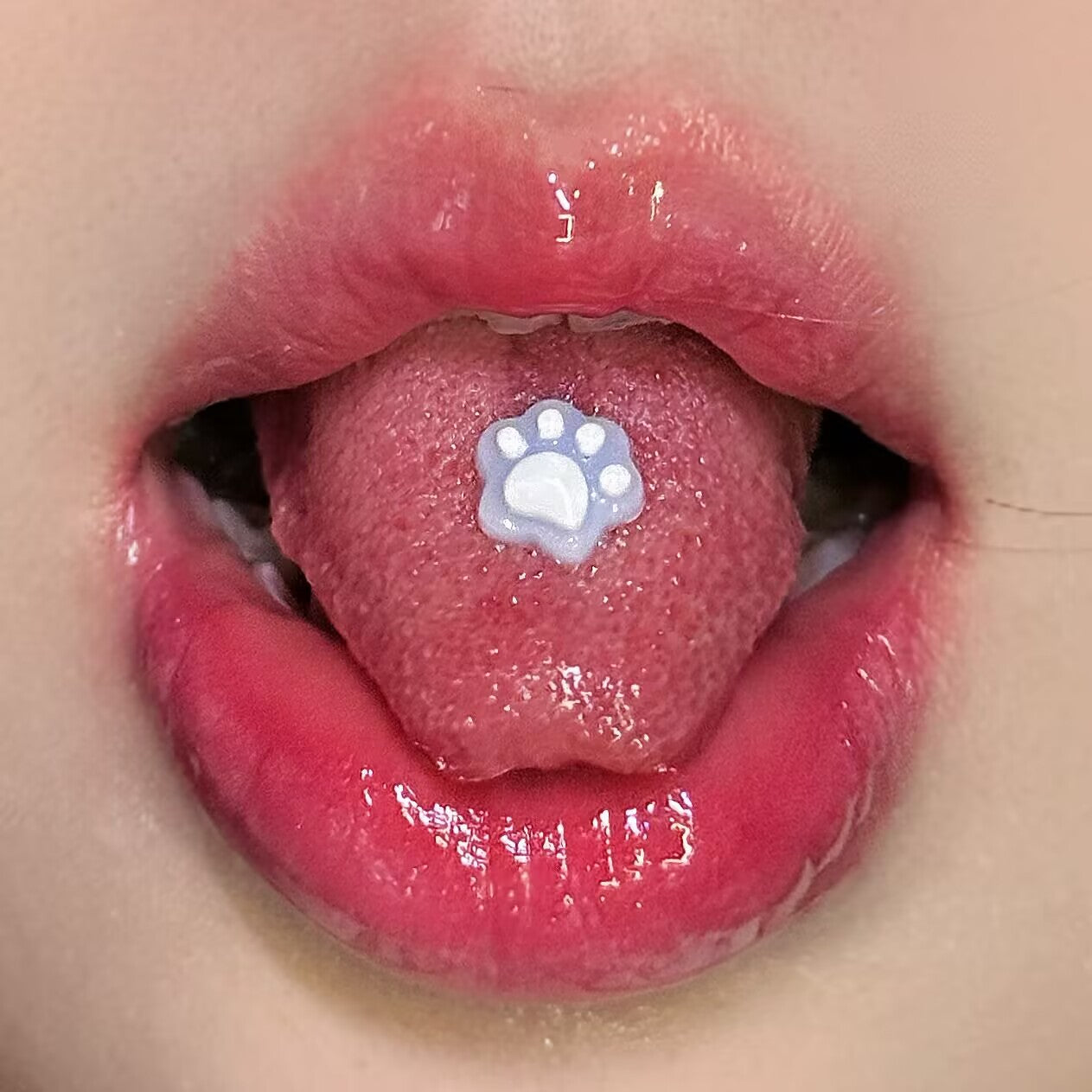 Pastel purple resin cat pad tongue ring on tongue, cute soft-girl aesthetic piercing accessory