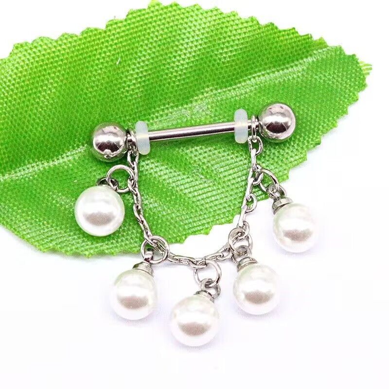 Elegant pearl dangle chain nipple barbell body piercing jewelry displayed on a vibrant green leaf