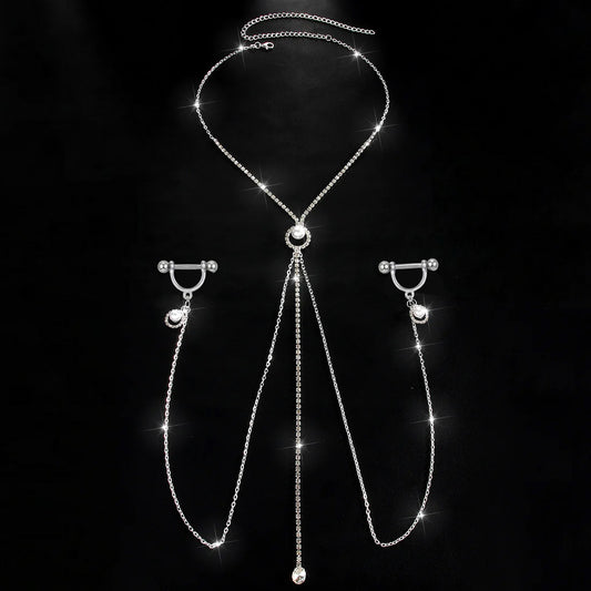 A complete single set of one-piece nipple ring body chain jewelry against a black background, featuring a rhinestone necklace with a central pearl charm connected to dual side chains and straight barbells.