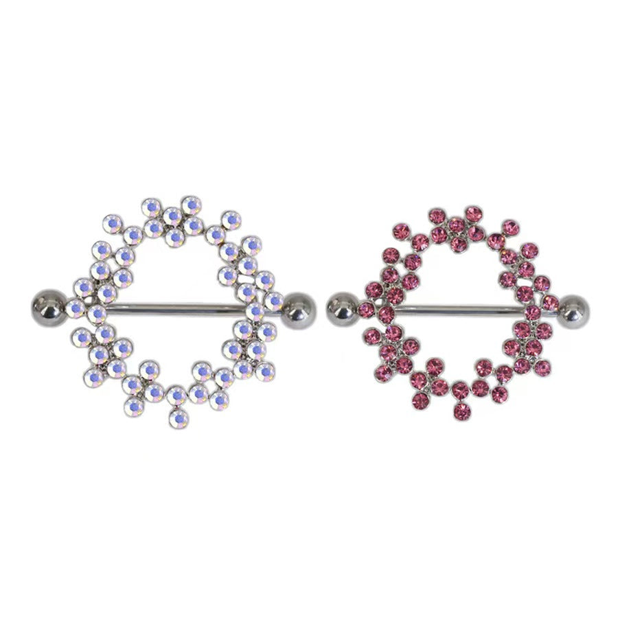 Two different styles of crystal nipple shield piercings side by side, one with pink rhinestones and one with AB iridescent crystals.