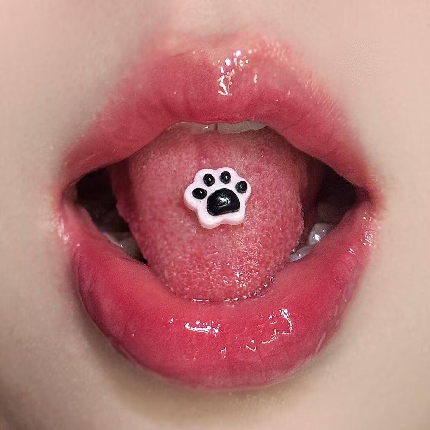 Pink and black resin cat paw tongue ring display, bold Y2K style aesthetic body jewelry