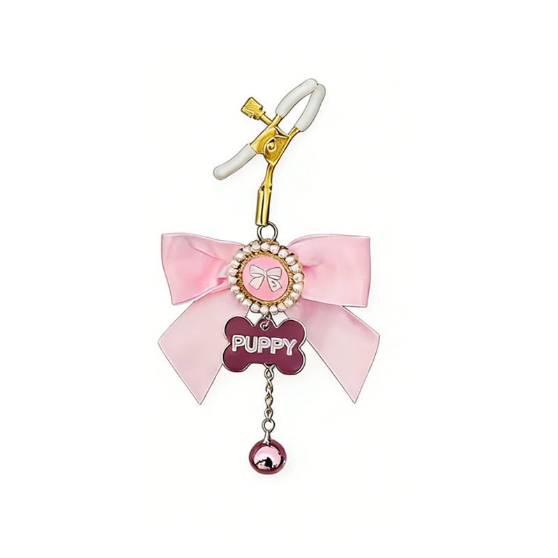 Single pink puppy play nipple clamp with a pearl-encrusted charm and bone-shaped tag.