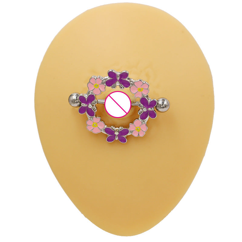 Detailed view of a woman wearing a high-quality nipple ring featuring a purple butterfly and pink flower design, elegant body jewelry
