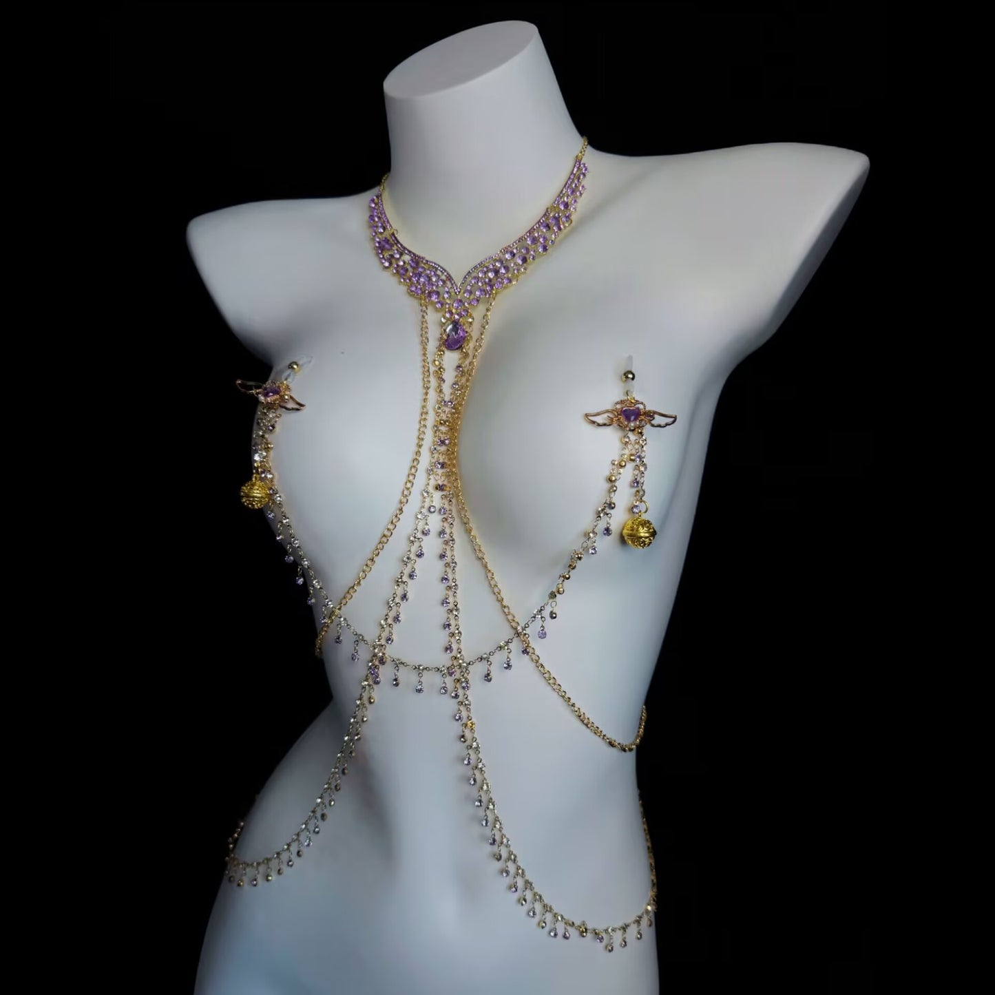 Front view of a purple rhinestone chest harness with golden filigree dangles and pierced nipple jewelry.