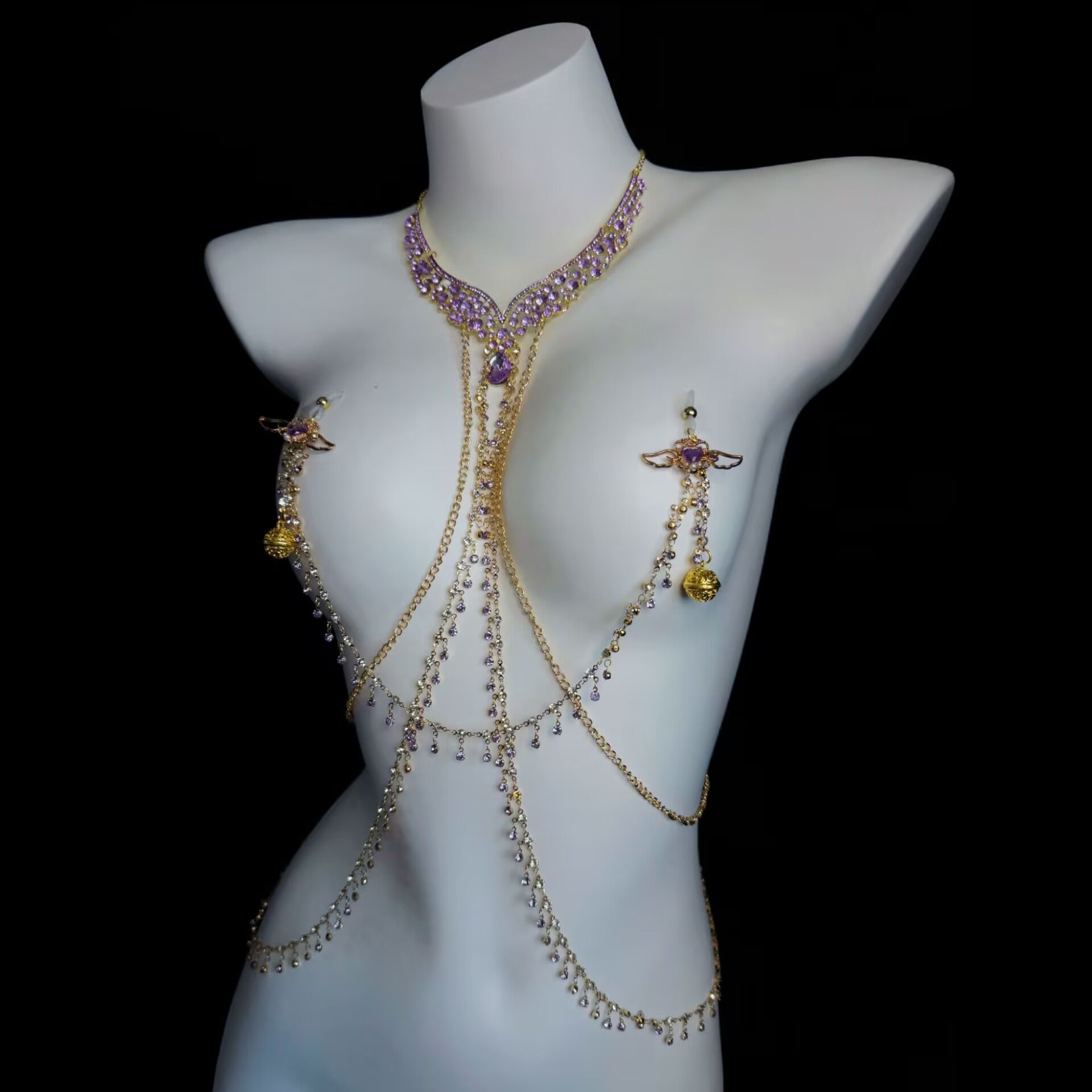 Front view of a purple rhinestone chest harness with golden filigree dangles and pierced nipple jewelry.