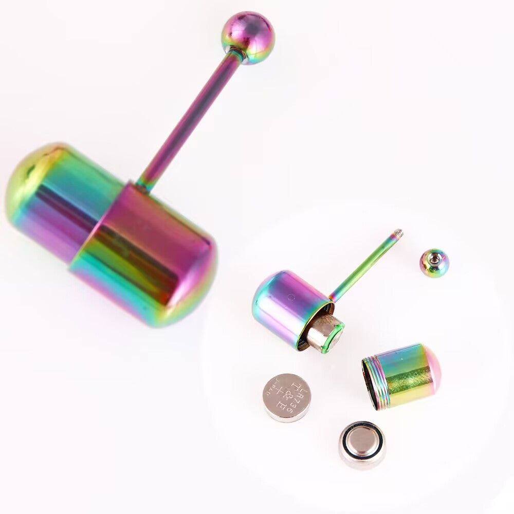 Exploded view of rainbow vibrating tongue ring capsule showing unscrewed top, internal compartment, and LR736 button batteries.