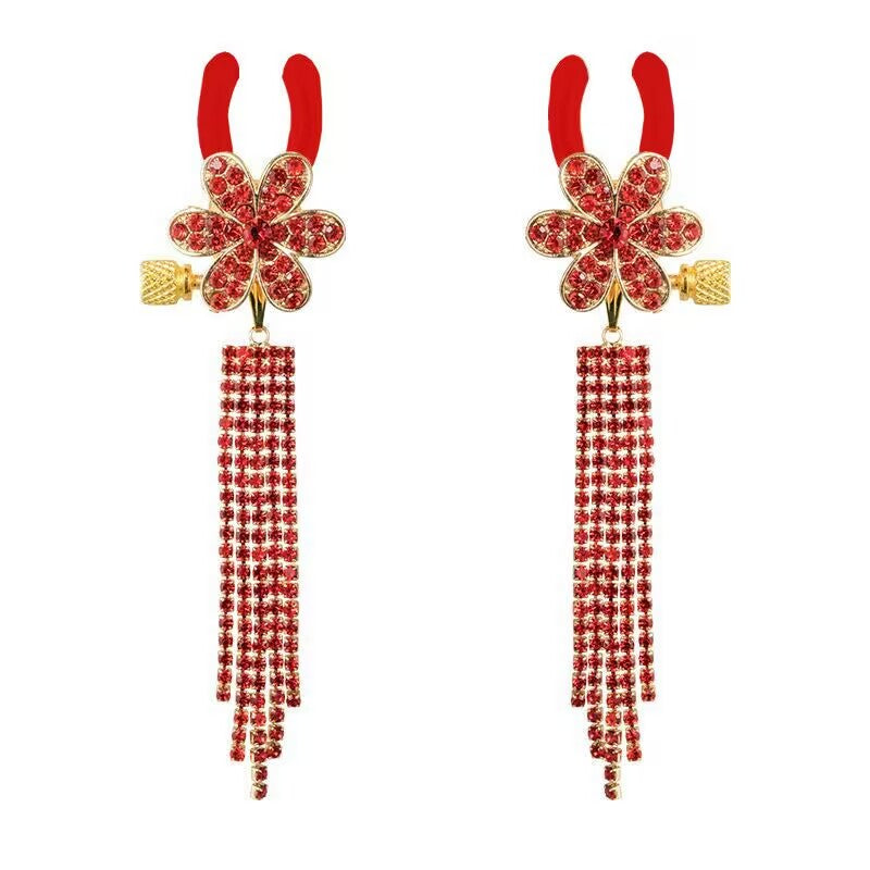 A pair of vibrant red crystal flower nipple clamps featuring long cascading tassels and red protective tips.