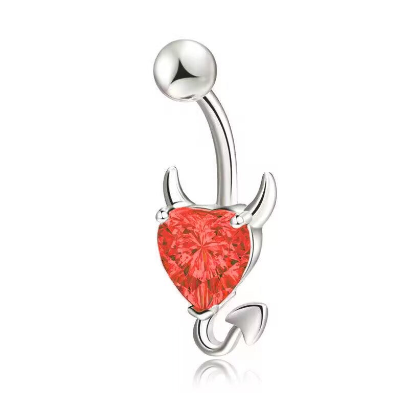 A bright fire red heart-cut crystal devil heart belly piercing bar with polished horns and arrow tail.