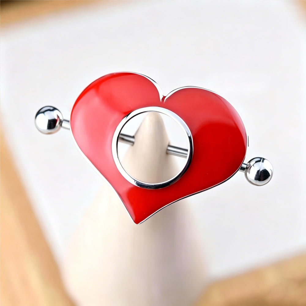 Close-up display of the enamel red heart nipple shield piercing jewelry on a soft white cone mold, highlighting the glossy finish and elegant circular cut-out design.