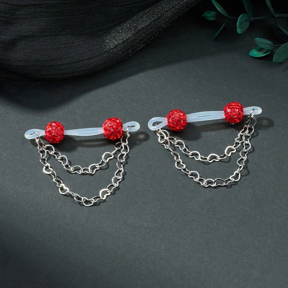 Pair of red sparkling-ball non-piercing nipple jewelry with translucent loops and draped heart chains