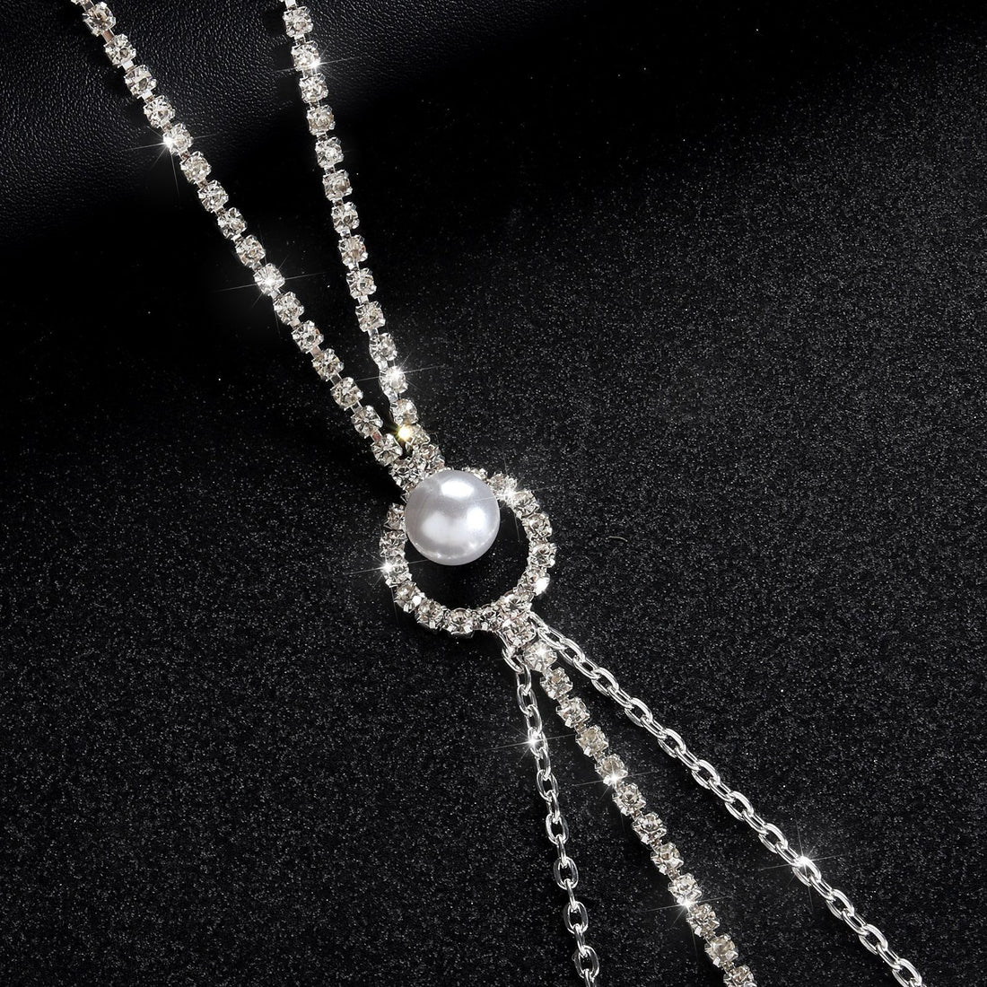 Detailed shot of the rhinestone choker necklace intersection on the body chain, showcasing a central white pearl rhinestone wreath charm branching into flowing silver chains.
