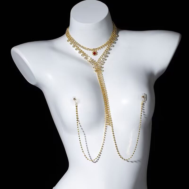 Sparkling gold rhinestone choker connected to a cascading chest chain and non-pierced nipple clamps worn on a mannequin.