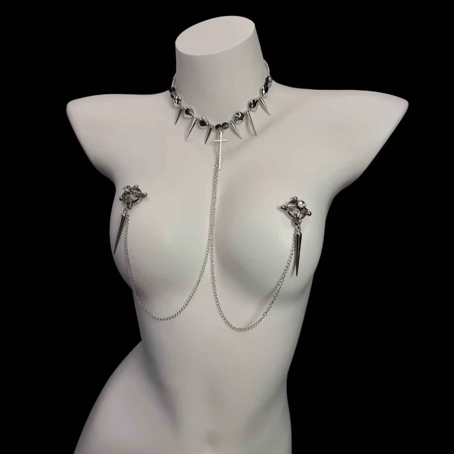 Gothic cross choker harness attached to rhinestone embellished circle nipple clamps with spike dangles.