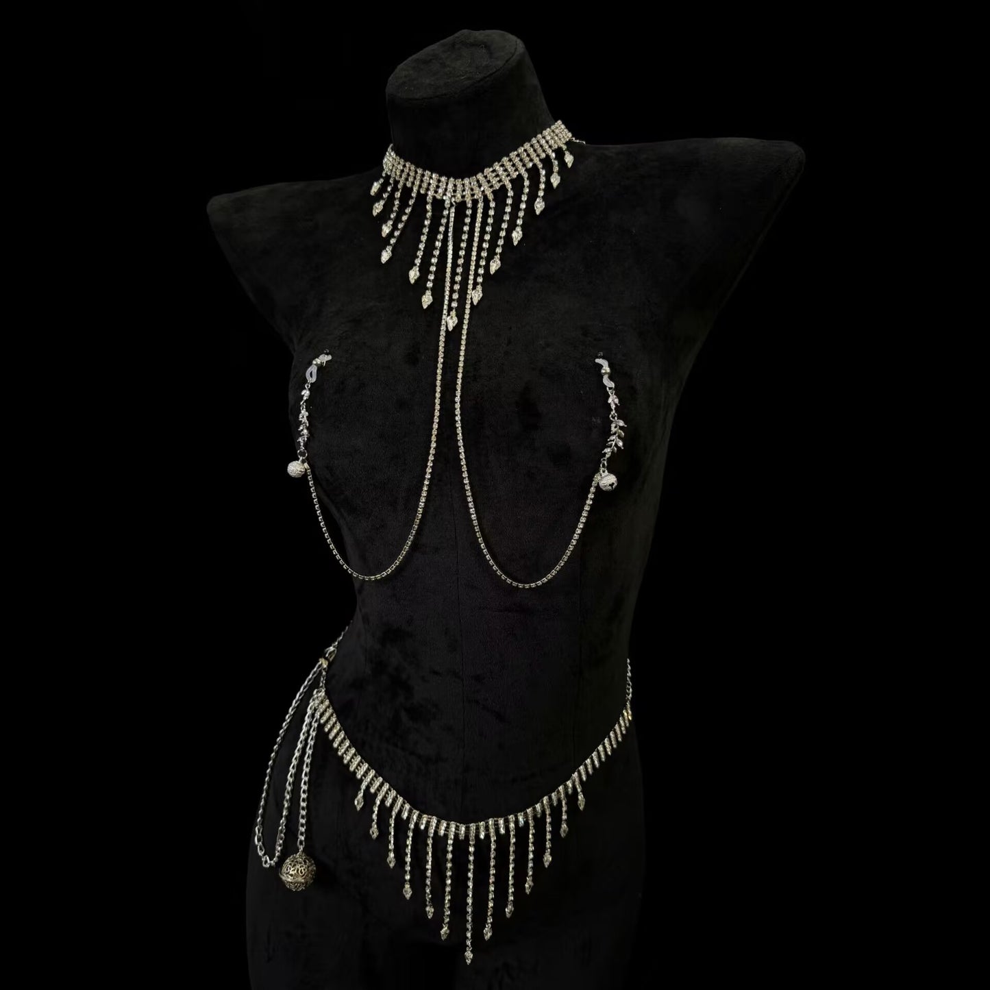 Full body jewelry set featuring a rhinestoned fringe choker necklace with connected nipple clamps and a matching tassel waist chain belt on a black mannequin.
