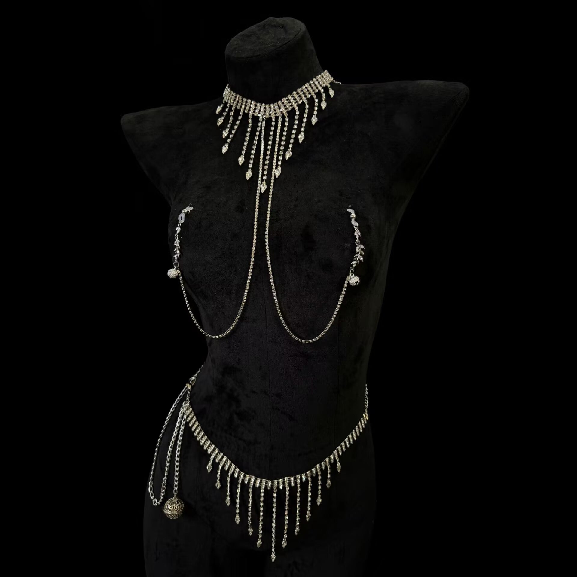 Full body jewelry set featuring a rhinestoned fringe choker necklace with connected nipple clamps and a matching tassel waist chain belt on a black mannequin.