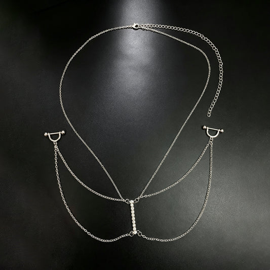 All-in-one silver nipple piercing body chain harness featuring a necklace chain and a central vertical row of sparkling rhinestones on a black background.