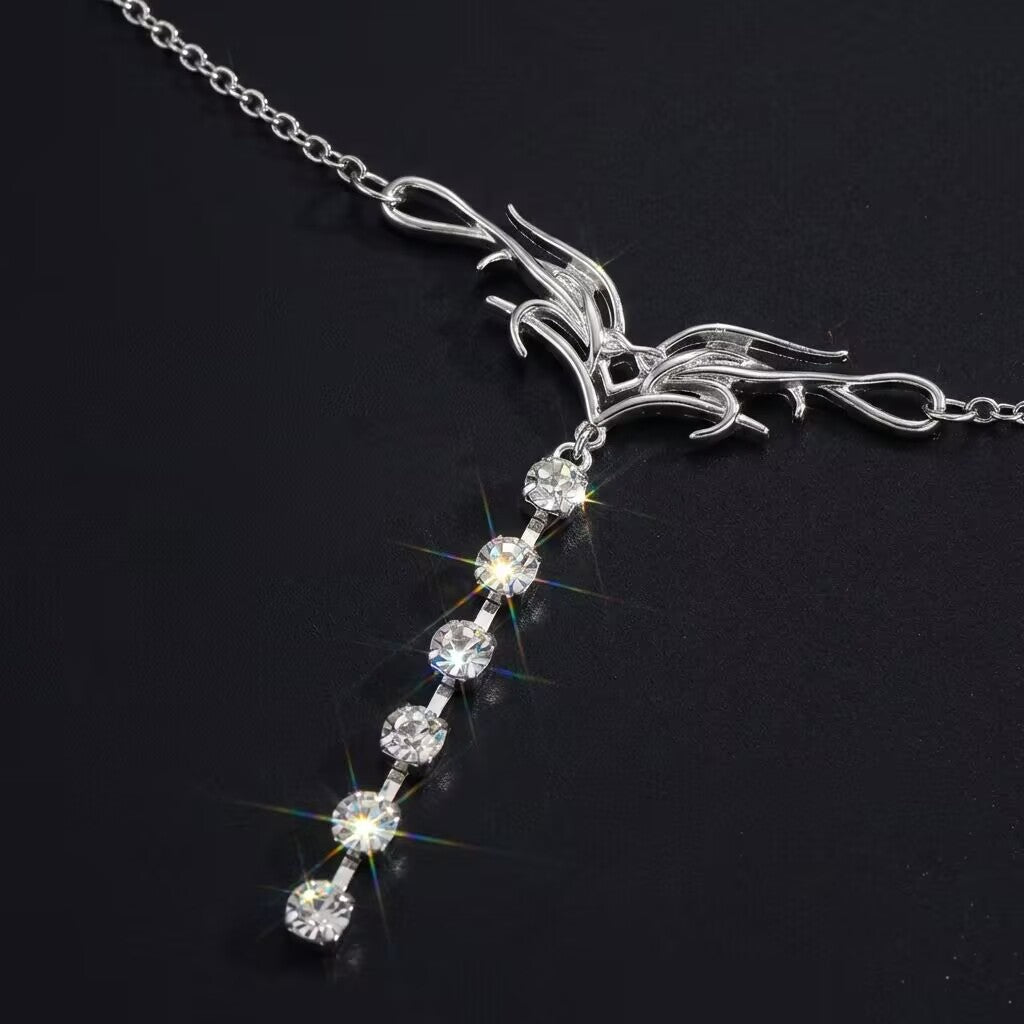 Macro detail of the liquid metal tribal flame design and sparkling rhinestone drop pendant