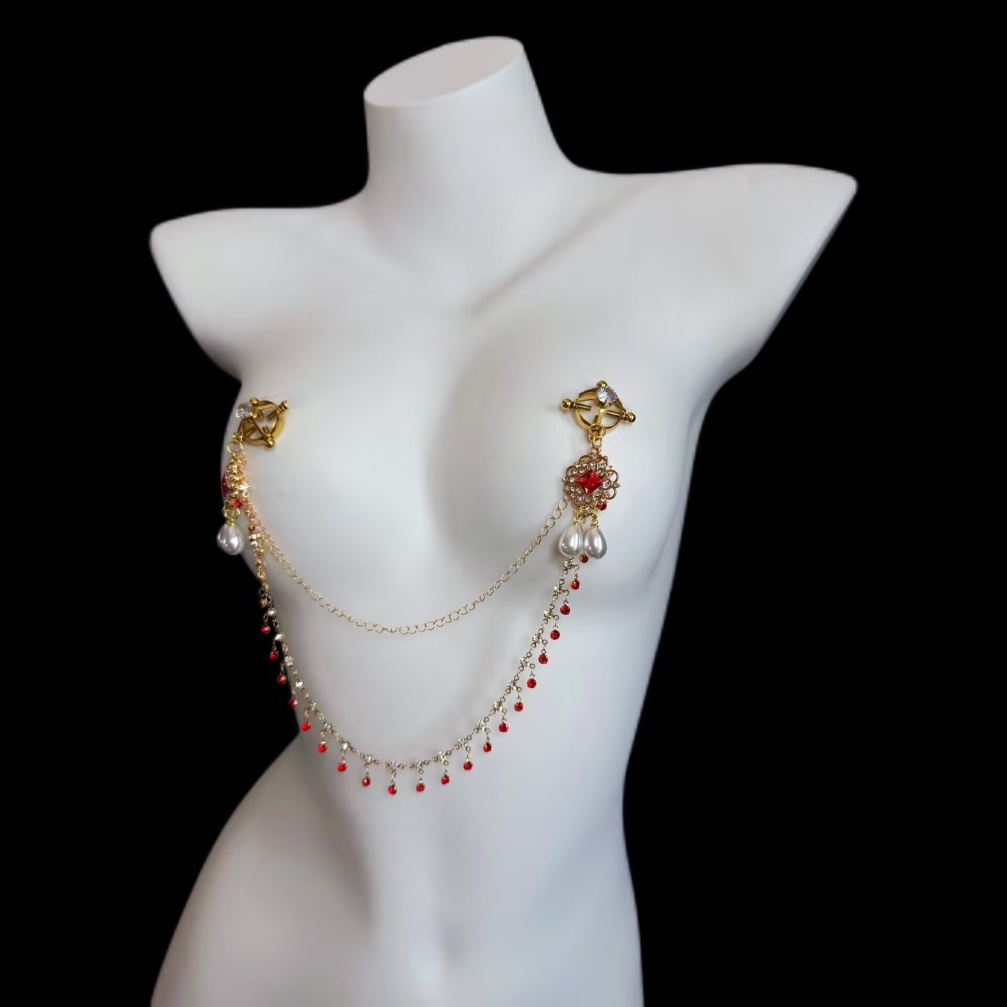 Ring-style metal clamp nipple body chain adorned with clear crystal studs, ruby centerstones, and dangling red bead fringes.