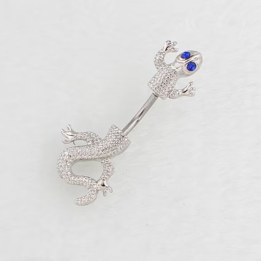 Gecko navel piercing jewelry with bright sapphire blue crystal eyes.