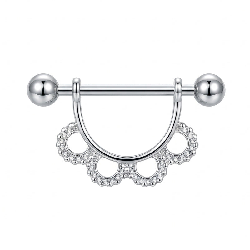 Front view of a decorative nipple shield featuring a delicate scalloped lace design with shimmering crystal accents on a clean white background.