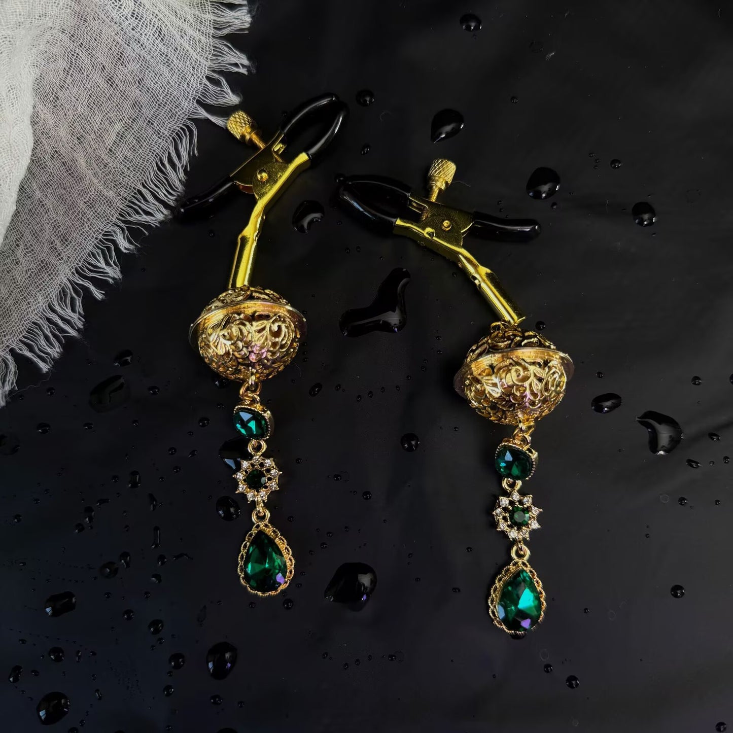 Adjustable screw alligator nipple clamps with protective rubber tips and antique gold emerald green dangle pendants.