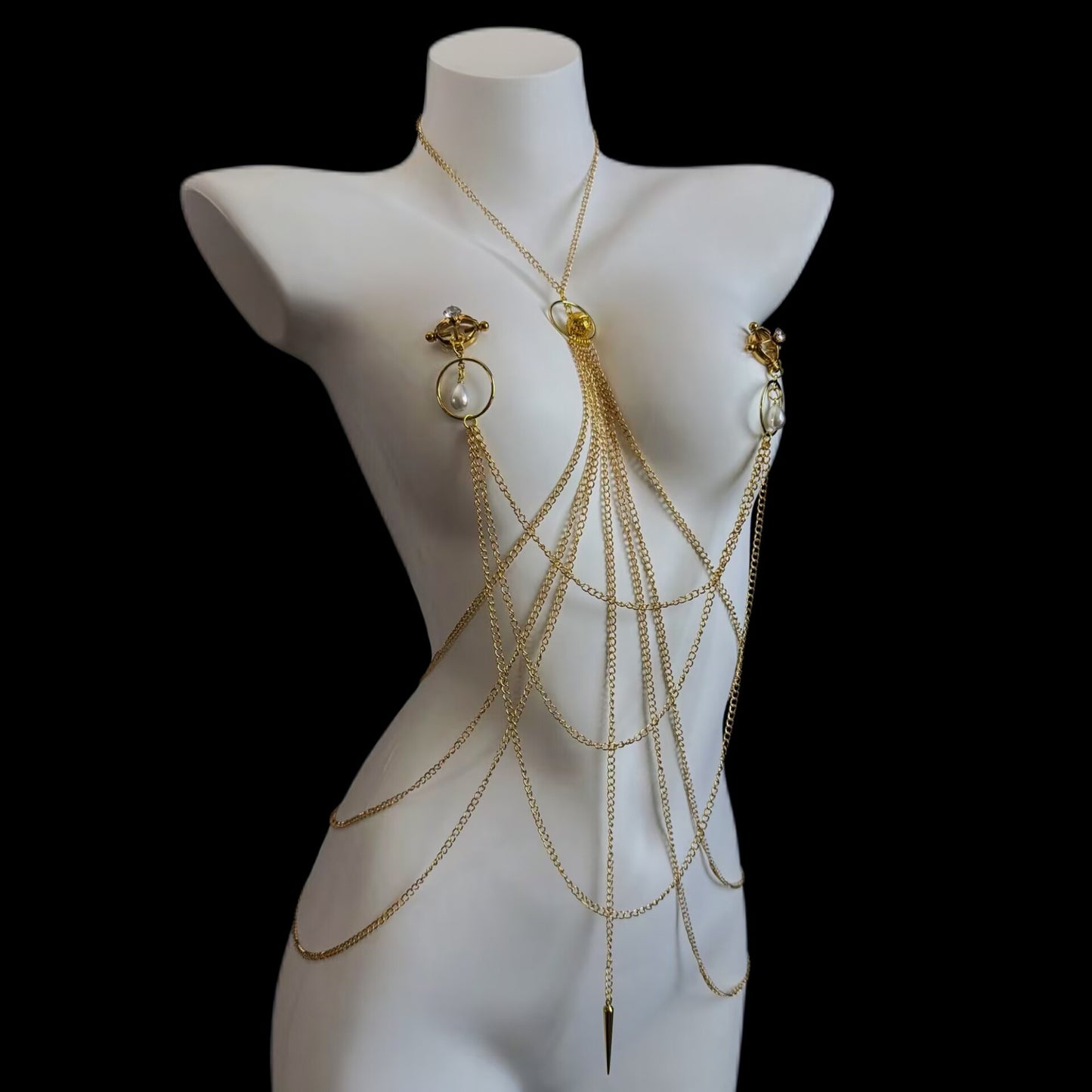 Adjustable screw-type non-pierced nipple clamps connected to a layered gold body chain harness