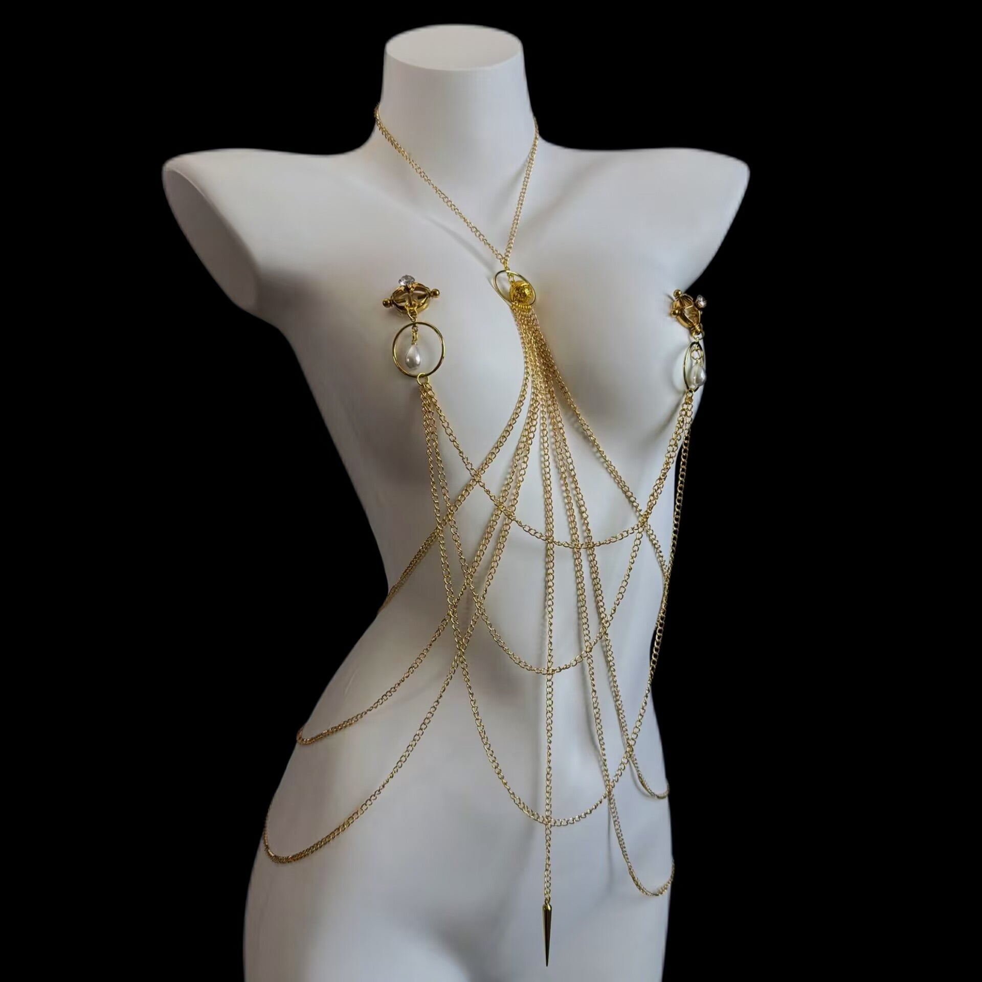 Adjustable screw-type non-pierced nipple clamps connected to a layered gold body chain harness