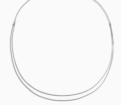 Minimalist silver double-layered belly chain jewelry laid flat against a white background.