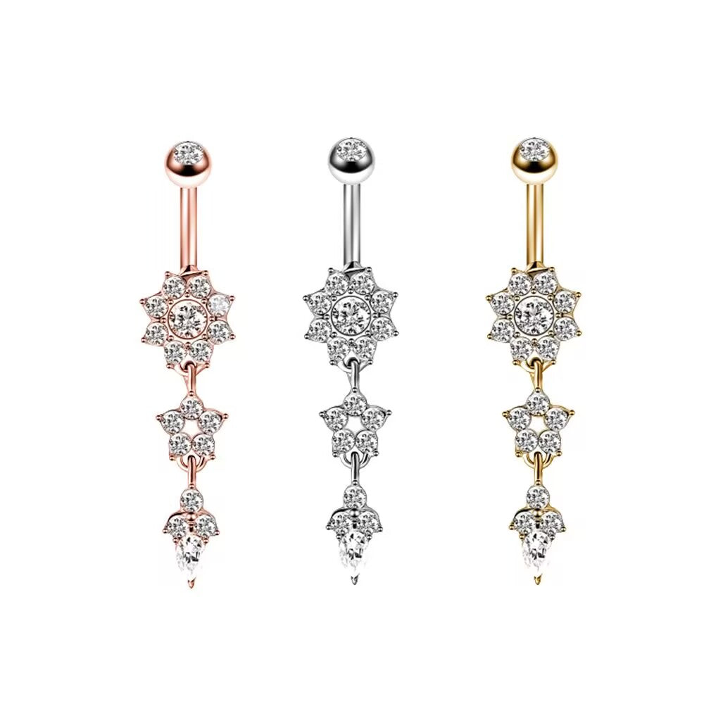 Three color options of crystal flower dangle belly button rings in silver, gold, and rose gold finishes.