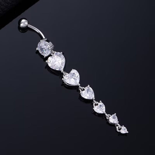 Silver dangle belly button ring featuring graduated heart cubic zirconia crystals on a black reflective background.