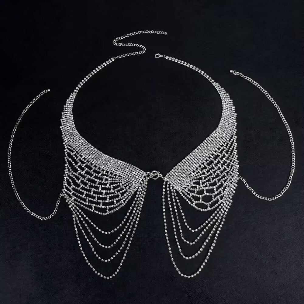 Silver crystal rhinestone bra chest harness laid out on a black background highlighting mesh pattern and drape.