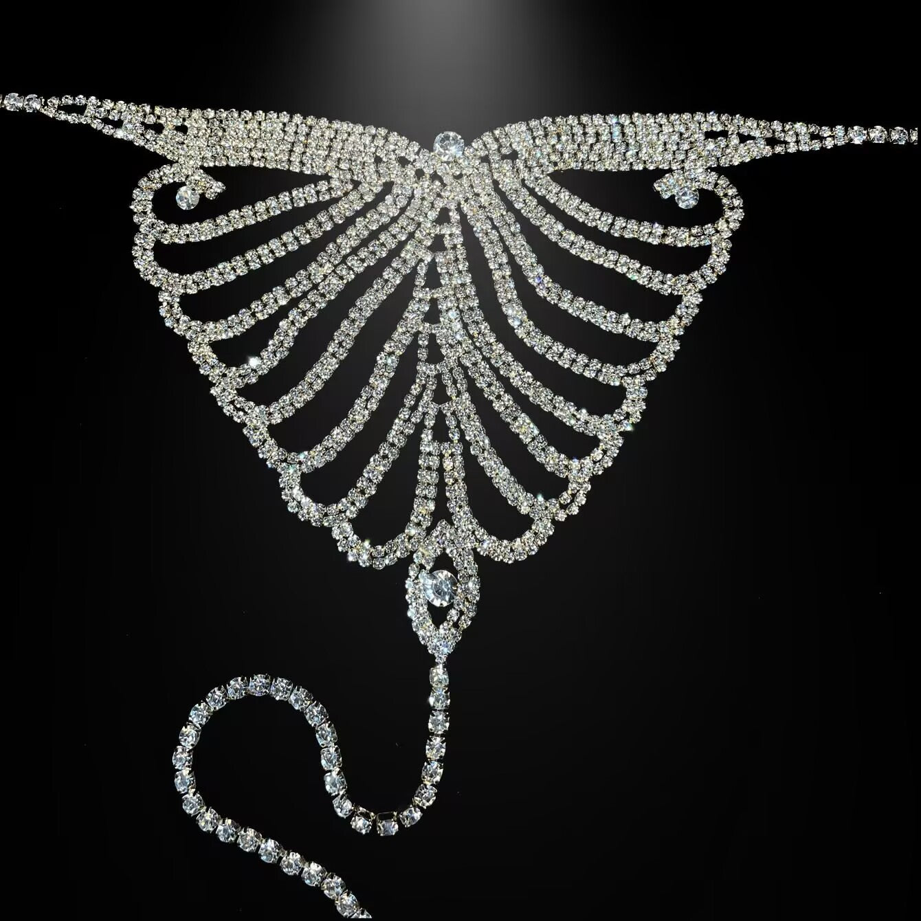 Silver rhinestone butterfly thong waist chain lay flat on black background.