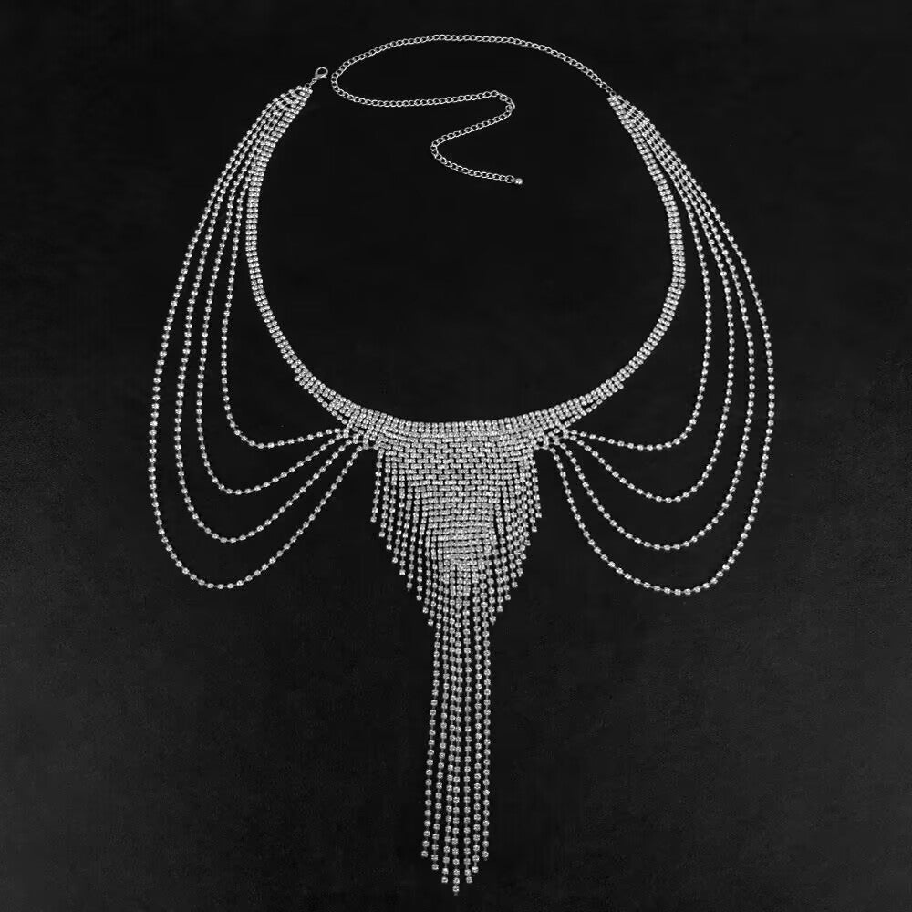 Silver rhinestone waist chain and belly harness on black background featuring center crystal fringe and side layers.