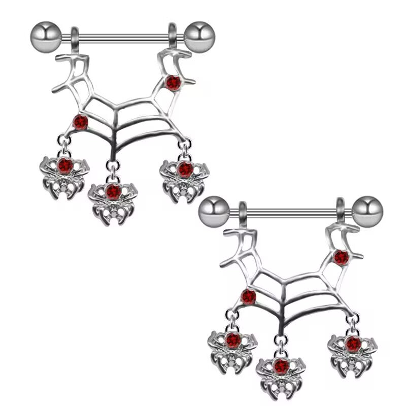 Pair of silver gothic spider web nipple shields with red crystals and dangling spider charms.