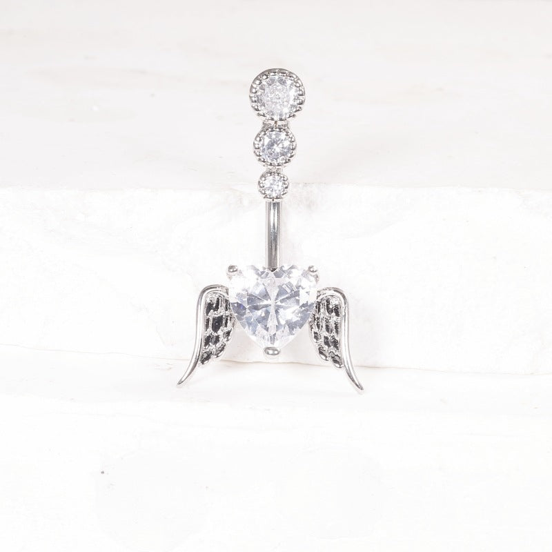 One silver-tone belly button ring with a clear cubic zirconia heart between angel wings
