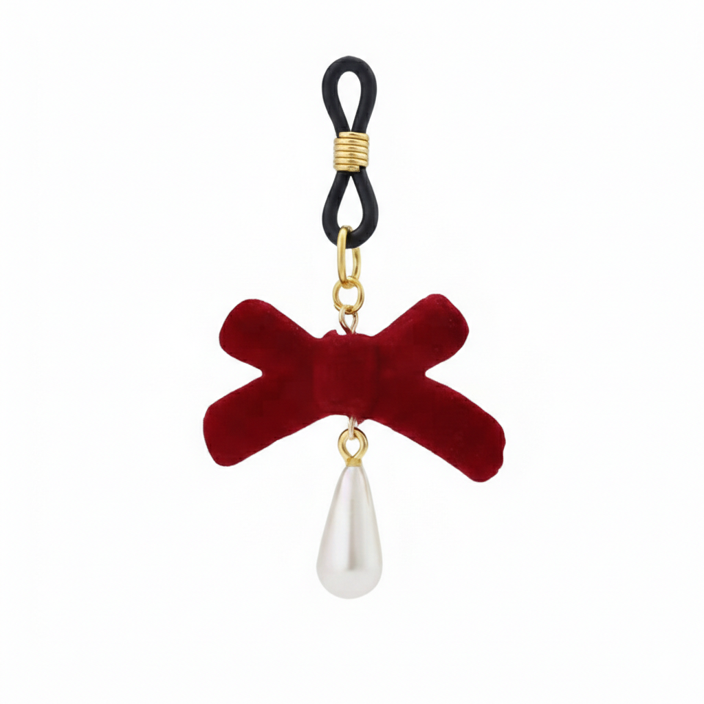 A single non-pierced nipple loop accessory featuring a deep red velvet bow and a hanging teardrop pearl charm on a clean white background.