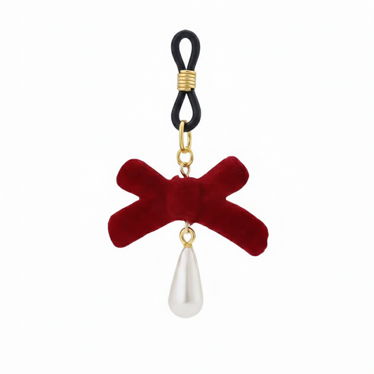 A single non-pierced nipple loop accessory featuring a deep red velvet bow and a hanging teardrop pearl charm on a clean white background.