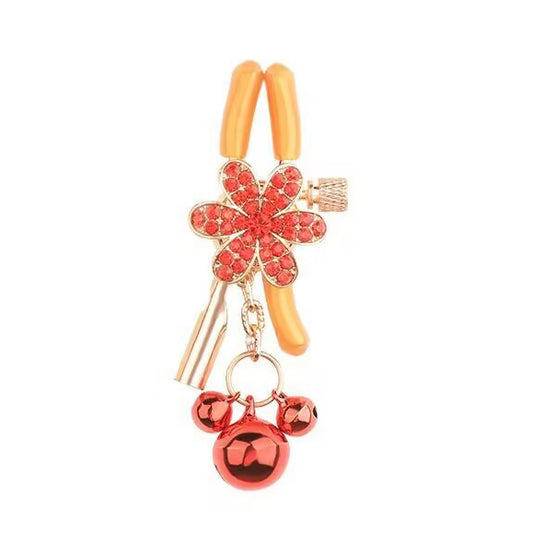Close-up of a single red flower adjustable sensory clamp with dangling bells.
