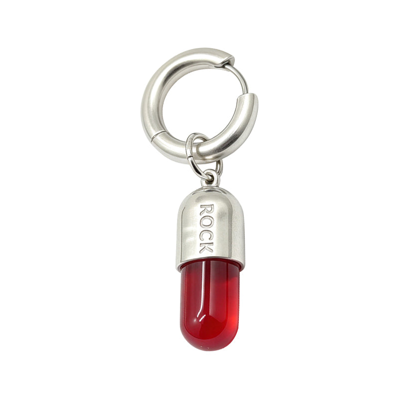 Single red pill dangle hoop earring with rock engraved silver cap isolated on a pure white background.