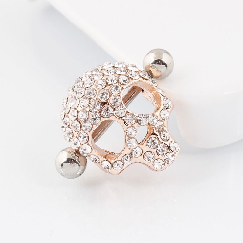 Close-up of a single rose gold skull nipple shield featuring a punk rock aesthetic and crystal detailing.