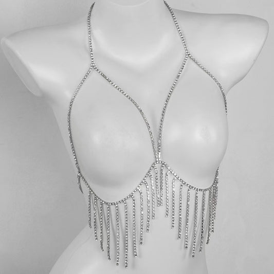 Sleek silver crystal bra body chain displayed on a female mannequin, highlighting how the sparkling rhinestone fringe wraps and contours around the underbust line.