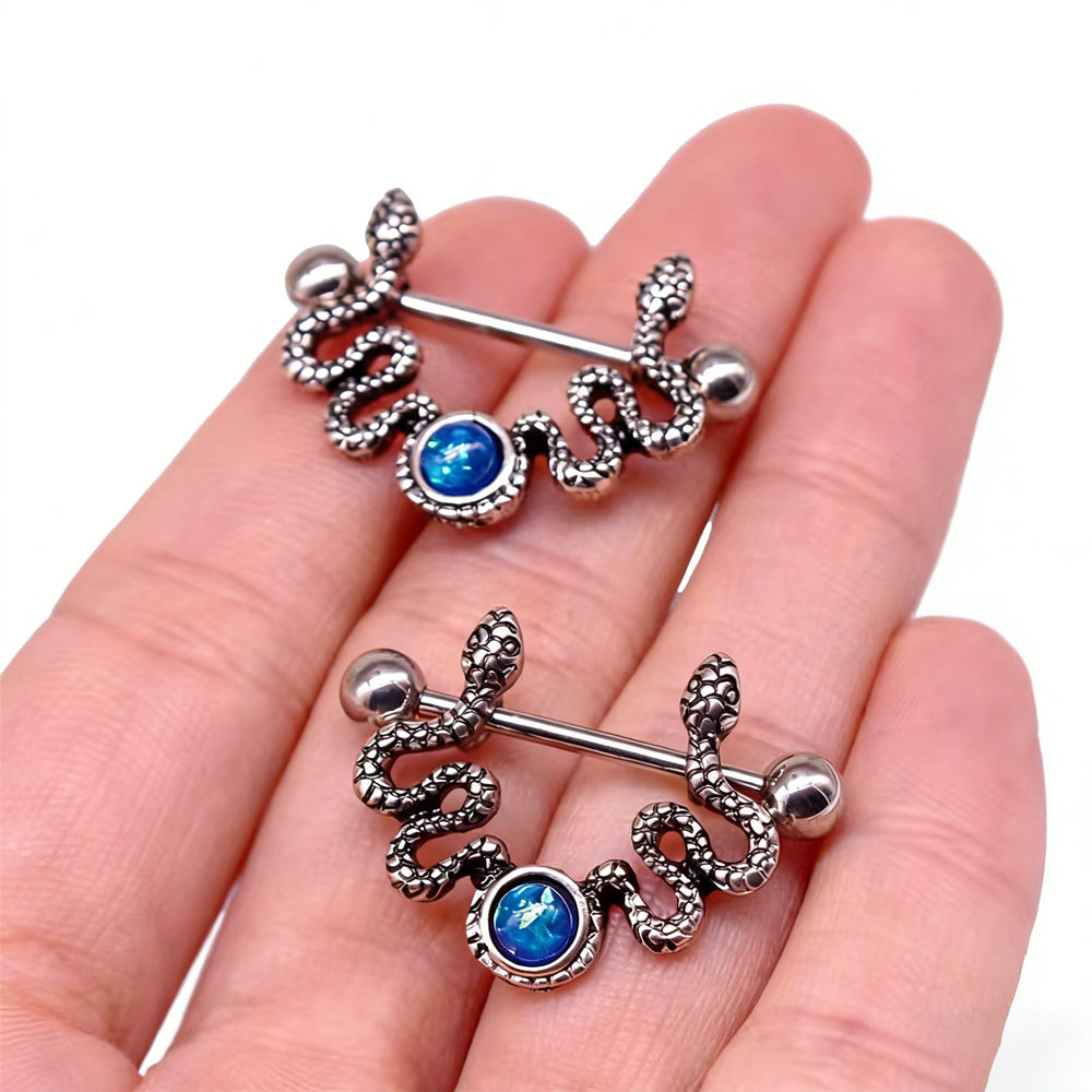 Hand-held view showing the scale of the snake nipple jewelry