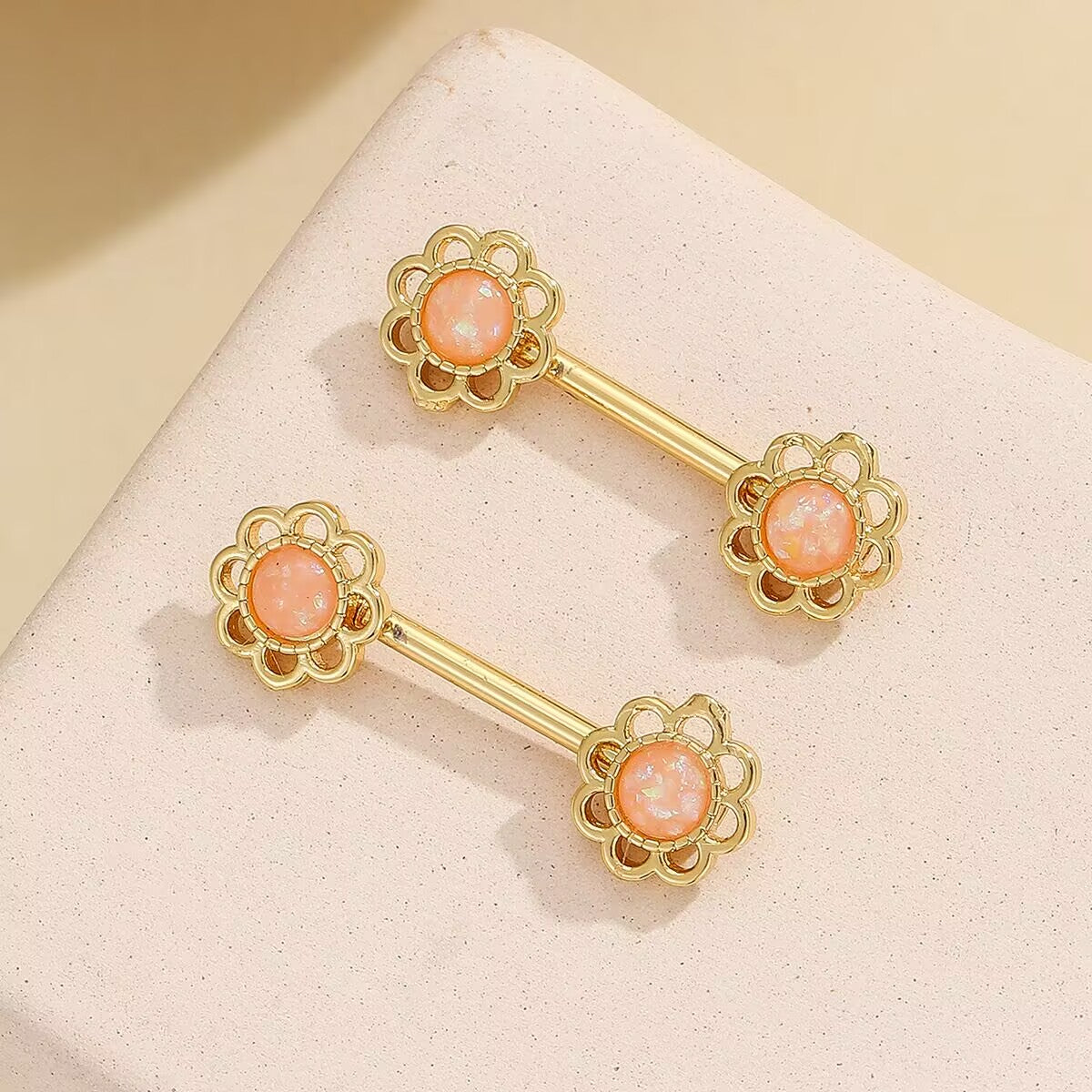 Soft peach colored floral faux nipple rings for a subtle and feminine look.
