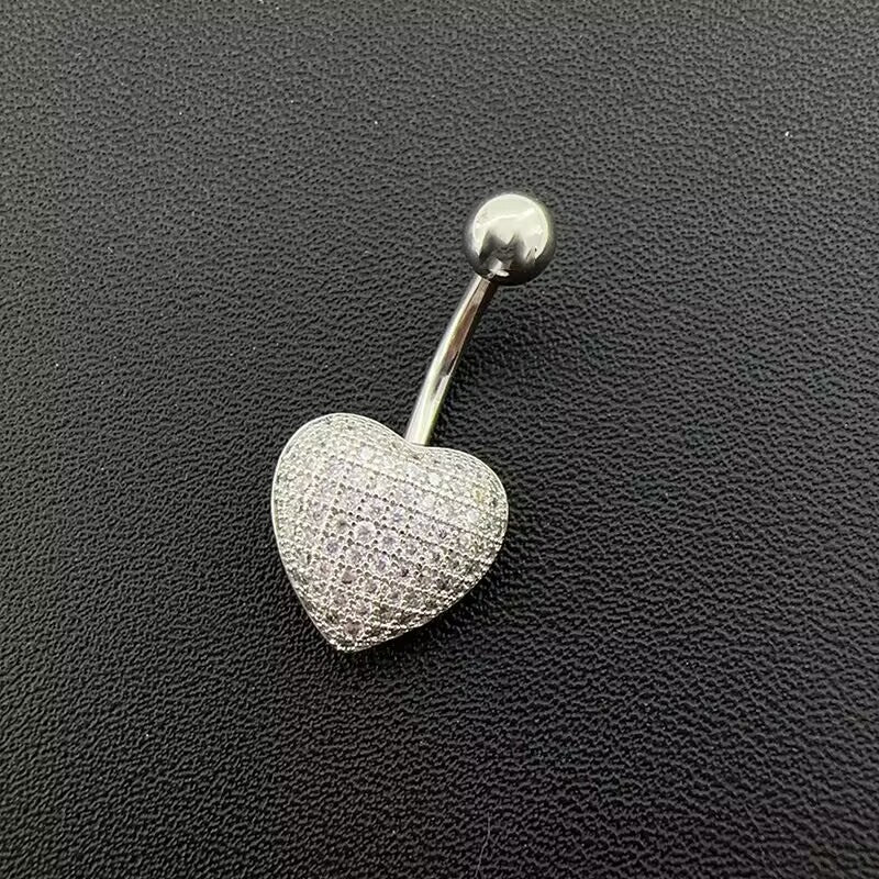 Full-pave CZ heart belly button ring with curved bar on black texture background