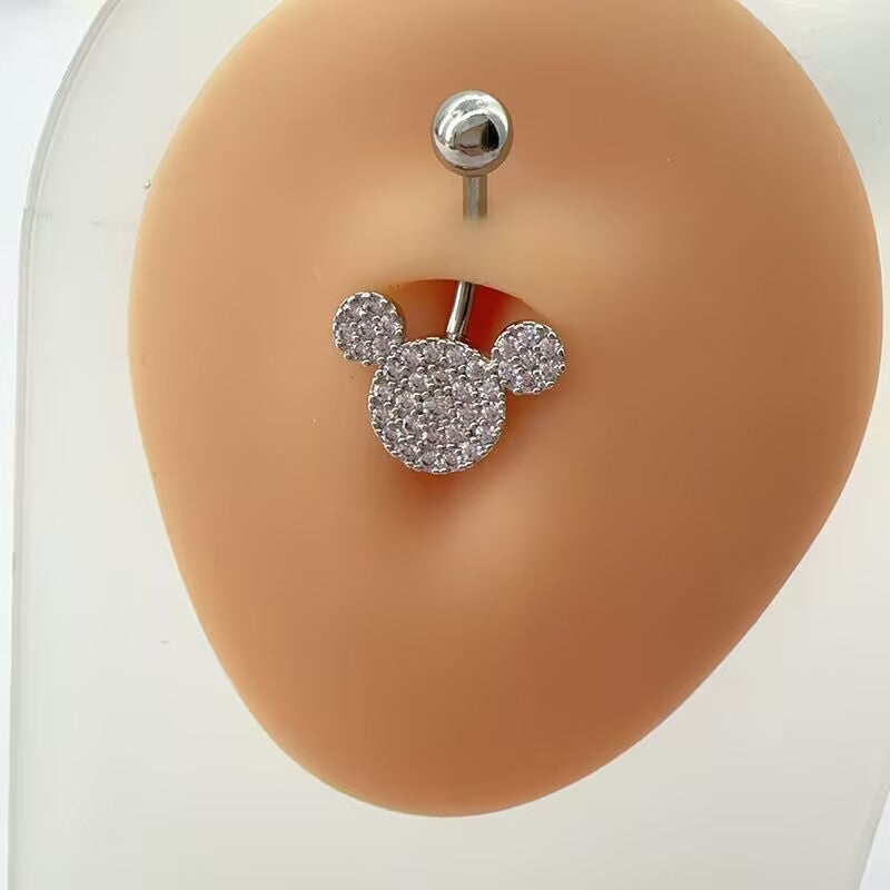 Sparkling mouse ear CZ pave curved belly button ring displayed on a realistic silicone navel model for body piercing jewelry styling.